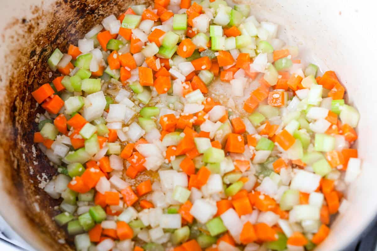 No tomatoes, no red sauce, just a rich, savory white bolognese loaded with beef, pork, bacon, white wine, and plenty of Parmesan. Tossed with noodles, it’s a fun and seriously delicious twist on classic Bolognese. Carrot, onion, celery and garlic cooking in the bacon grease.