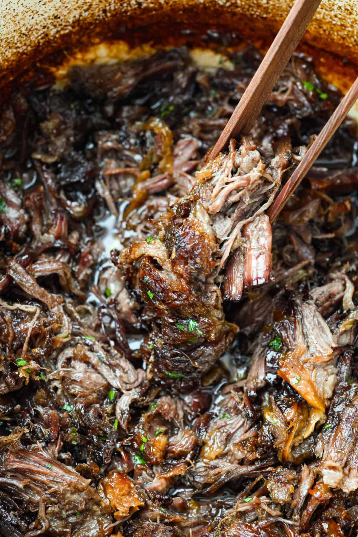 Caramelized chuck roast is everything I want in a cozy dinner. The beef cooks low and slow until it practically falls apart, then gets sprinkled with brown sugar and broiled until the edges are sticky, caramelized, and SO good. Close up of a scoop of caramelized chuck roast.