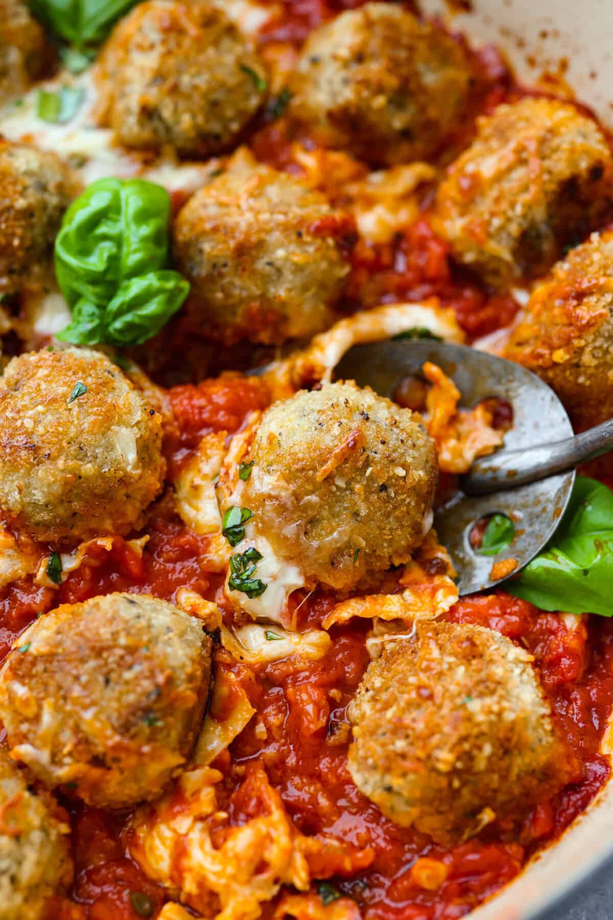 Close up picture of the chicken parmesan meatballs all browned and baked and ready to eat. 