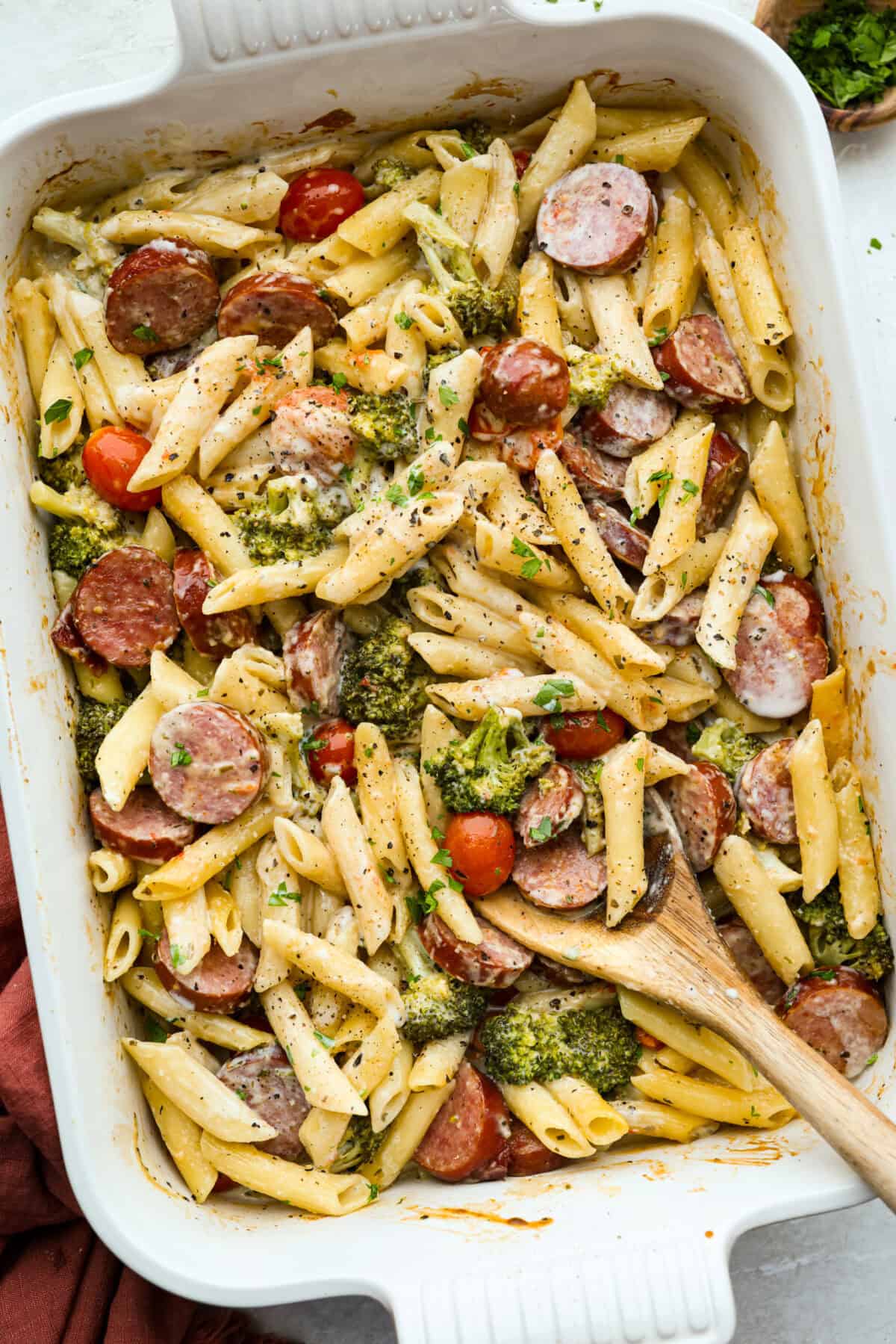 Baking dish with creamy sausage pasta. 