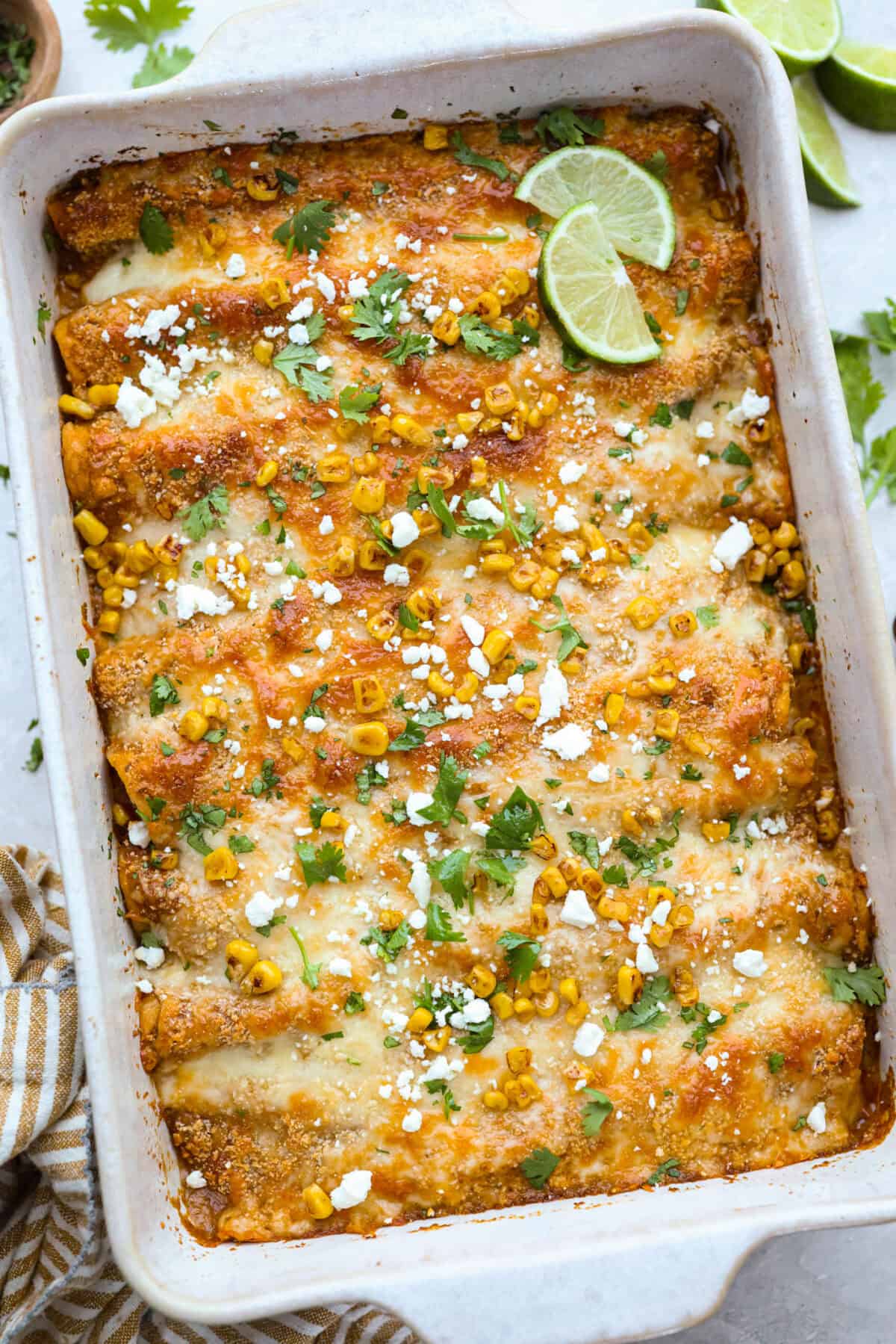 Baking dish with street corn chicken enchiladas. 
