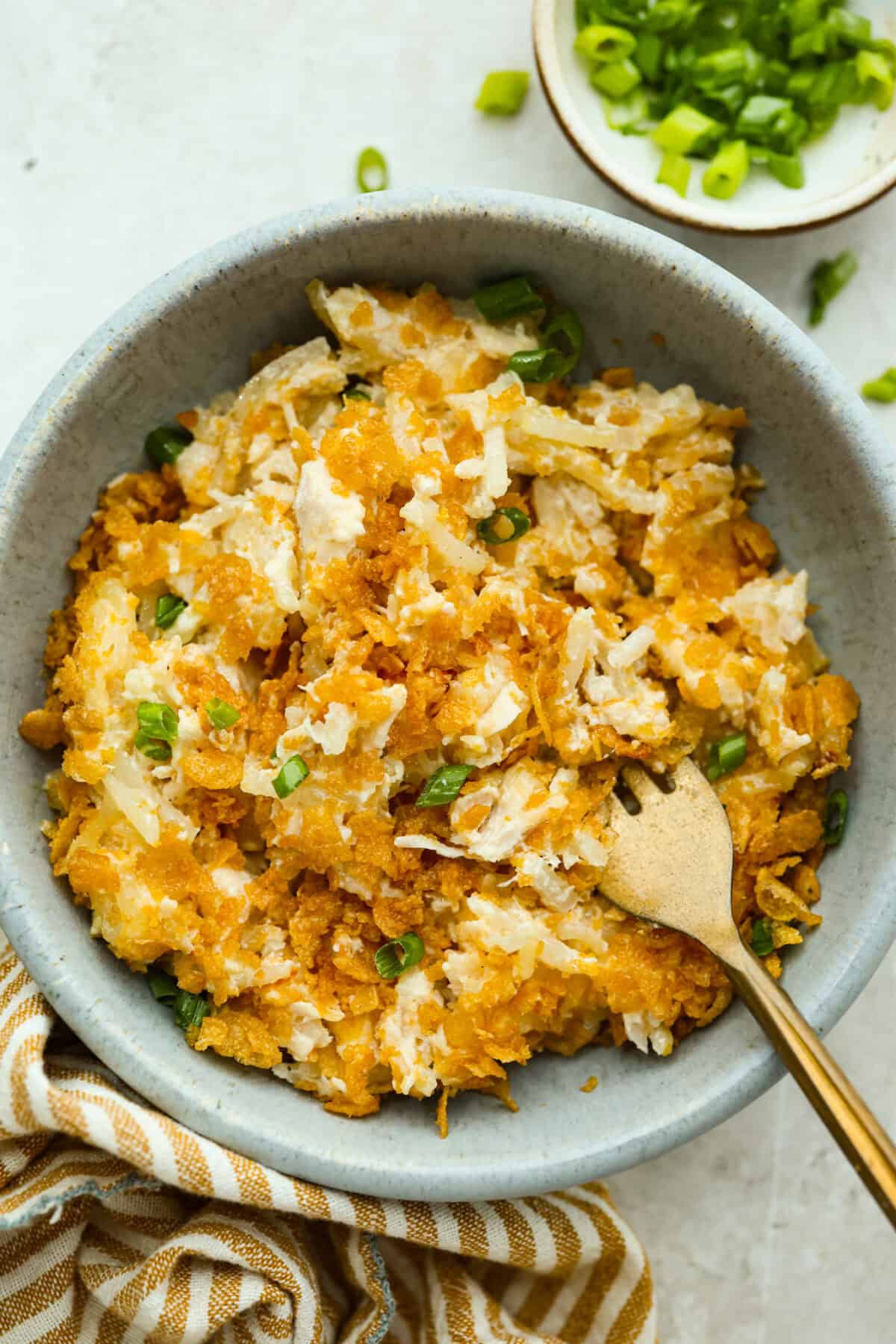 Bowl with a serving of funeral potatoes and chicken casserole. 