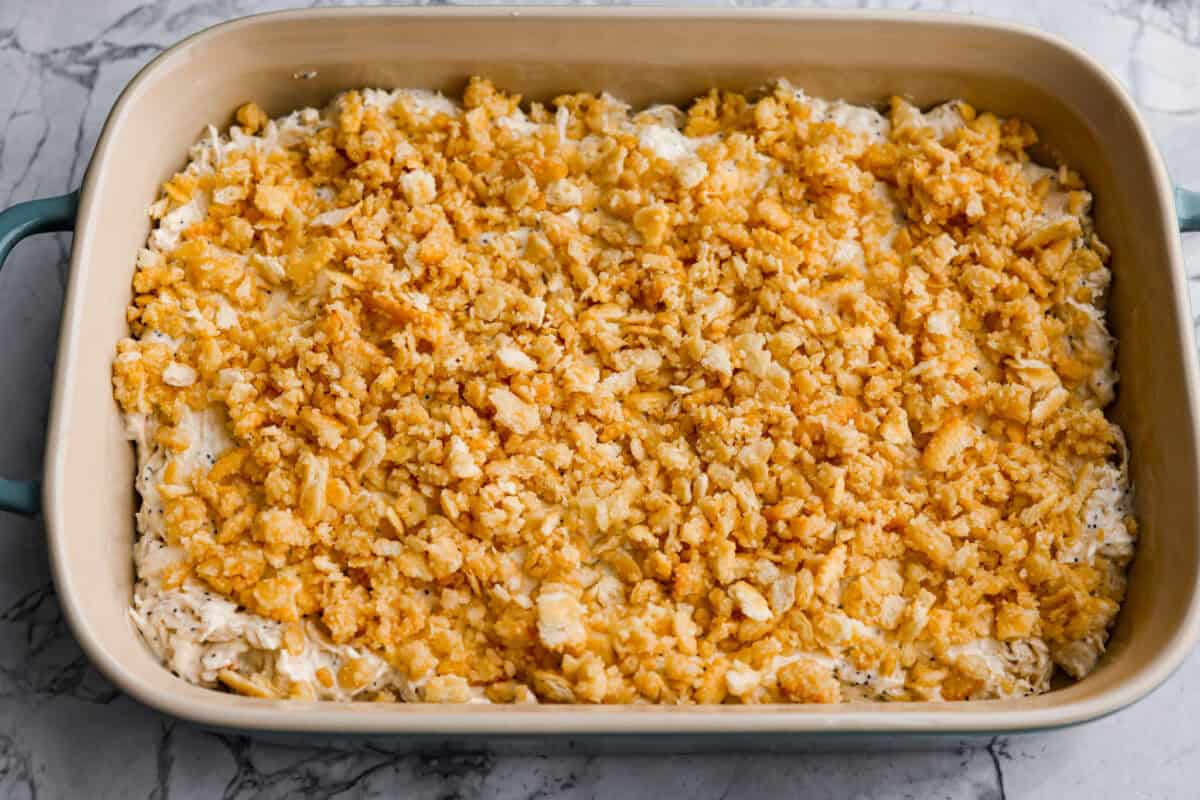 Poppy seed chicken casserole is creamy, cozy, and so easy to make! Tender chicken is topped with buttery Ritz crackers for the perfect crunch, and it’s ready in just 35 minutes. Ritz cracker topping added to the top of the mixture.