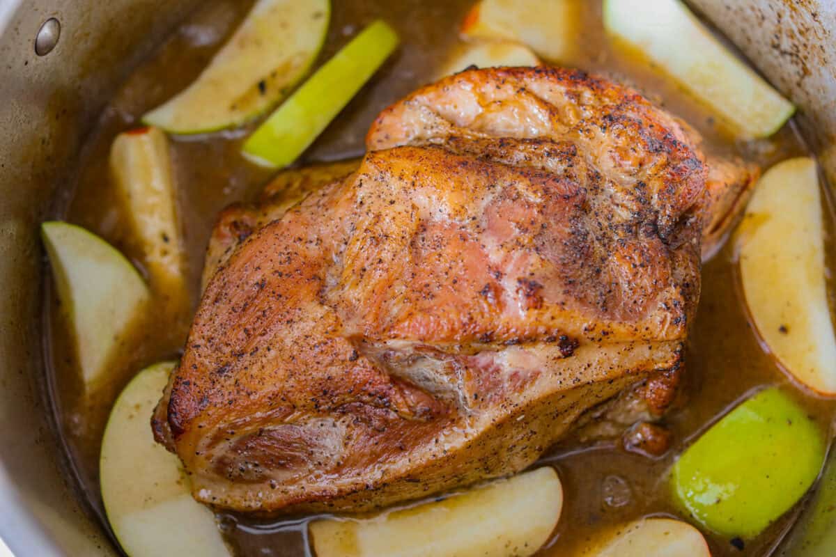 If you love a good Sunday roast, this apple cider pork roast needs to be on your fall menu. Tender pork cooks with apple cider, herbs, and sweet-tart apples until it’s fall-apart tender and perfect over creamy mashed potatoes. Apple cider pork roast all cooked and ready to shred.