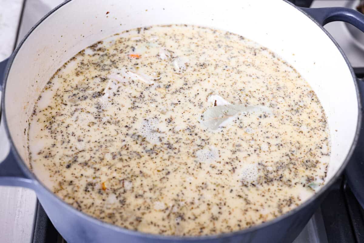 Chicken broth and evaporated milk added to the pot. 