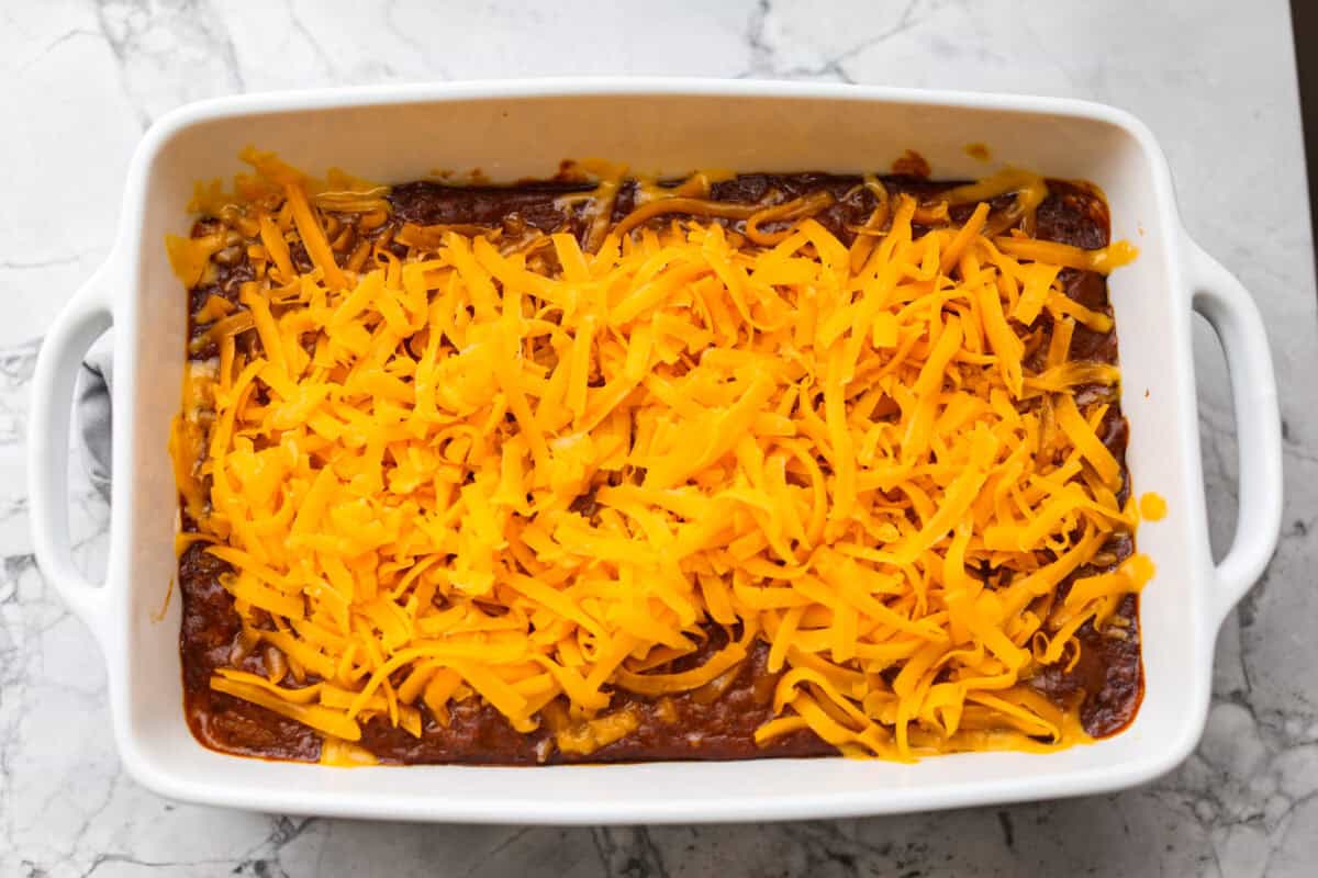 Cincinnati chili dip is the easiest game day appetizer you didn’t know you needed! Also called Skyline dip, it has just three ingredients: cream cheese, Cincinnati-style chili, and melty cheddar cheese. Shredded cheddar cheese added to the top of the par baked cream cheese and chili.