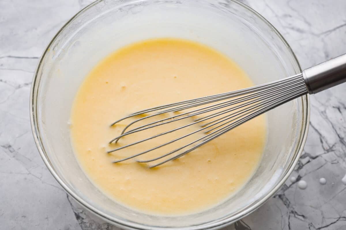 Wet ingredients whisked together in a mixing bowl. 