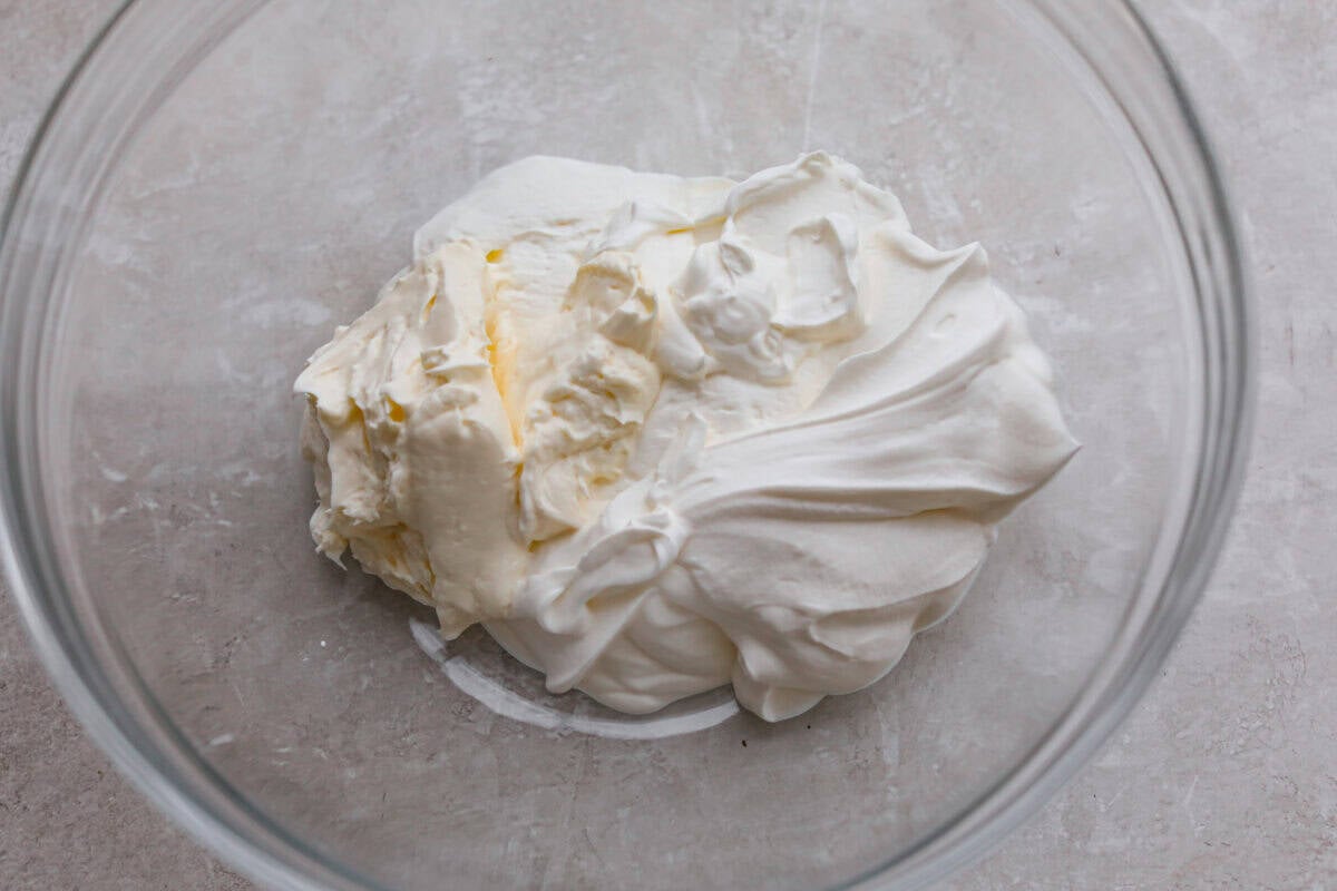Cream cheese and sour cream in a mixing bowl.