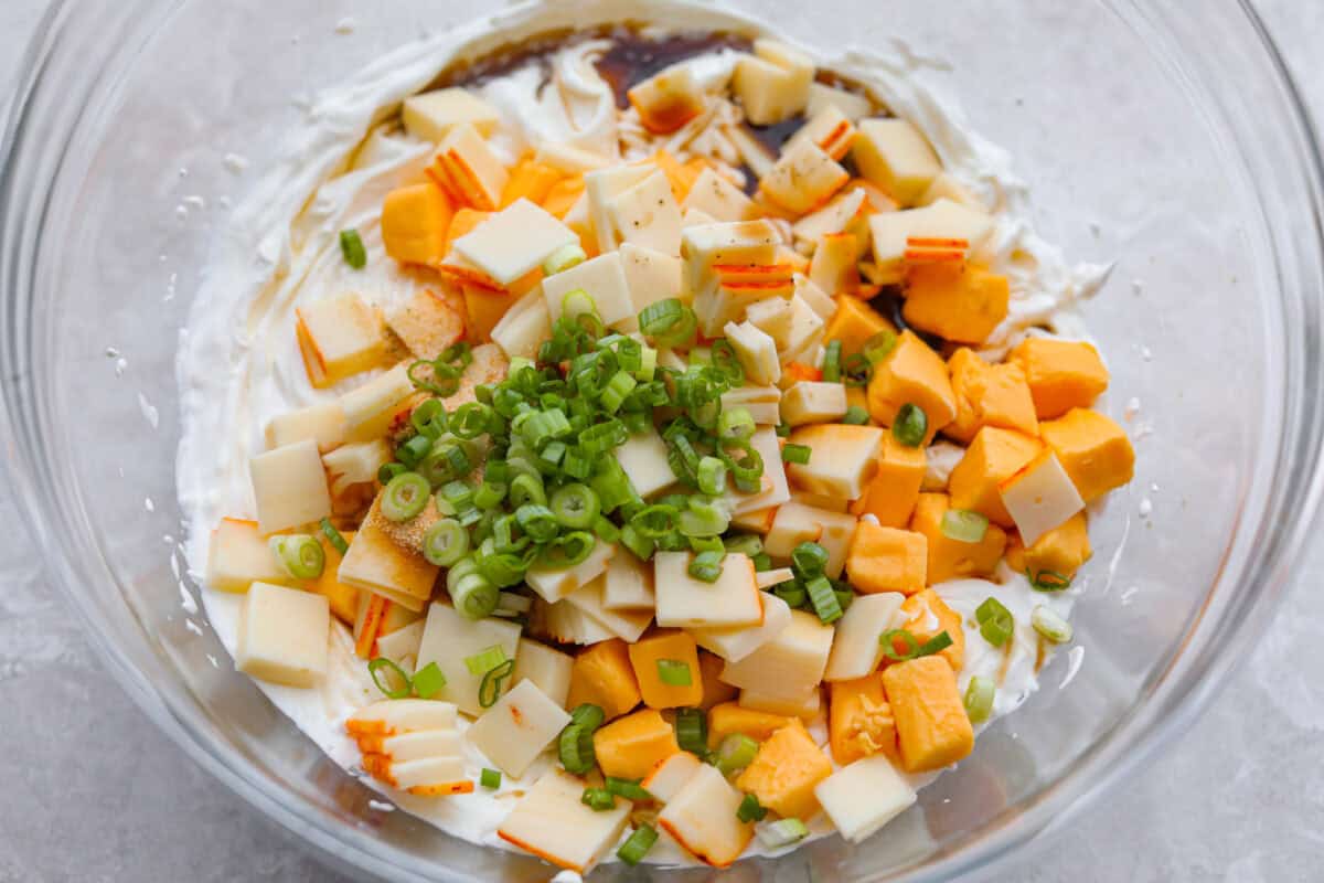 Cheeses, onion, Worcestershire and seasonings added to the cream cheese and sour cream mixture.