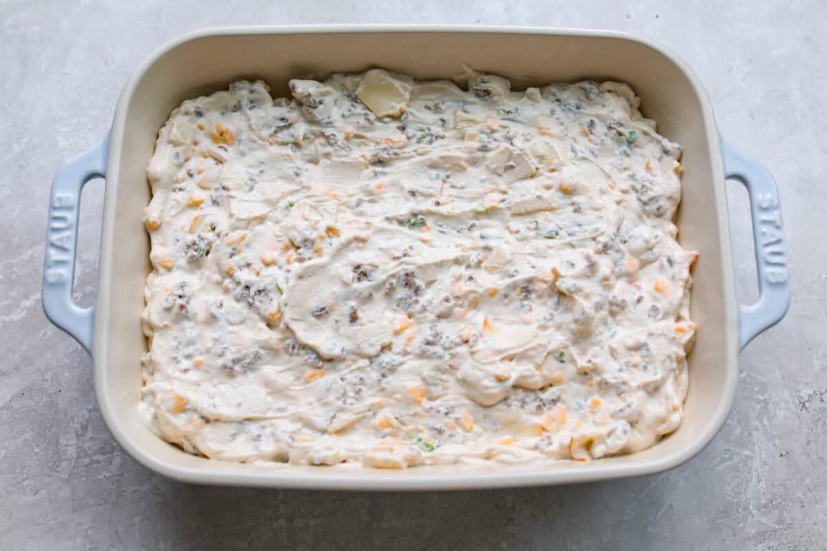 All of the hissy fit dip ingredients added to a baking dish. 