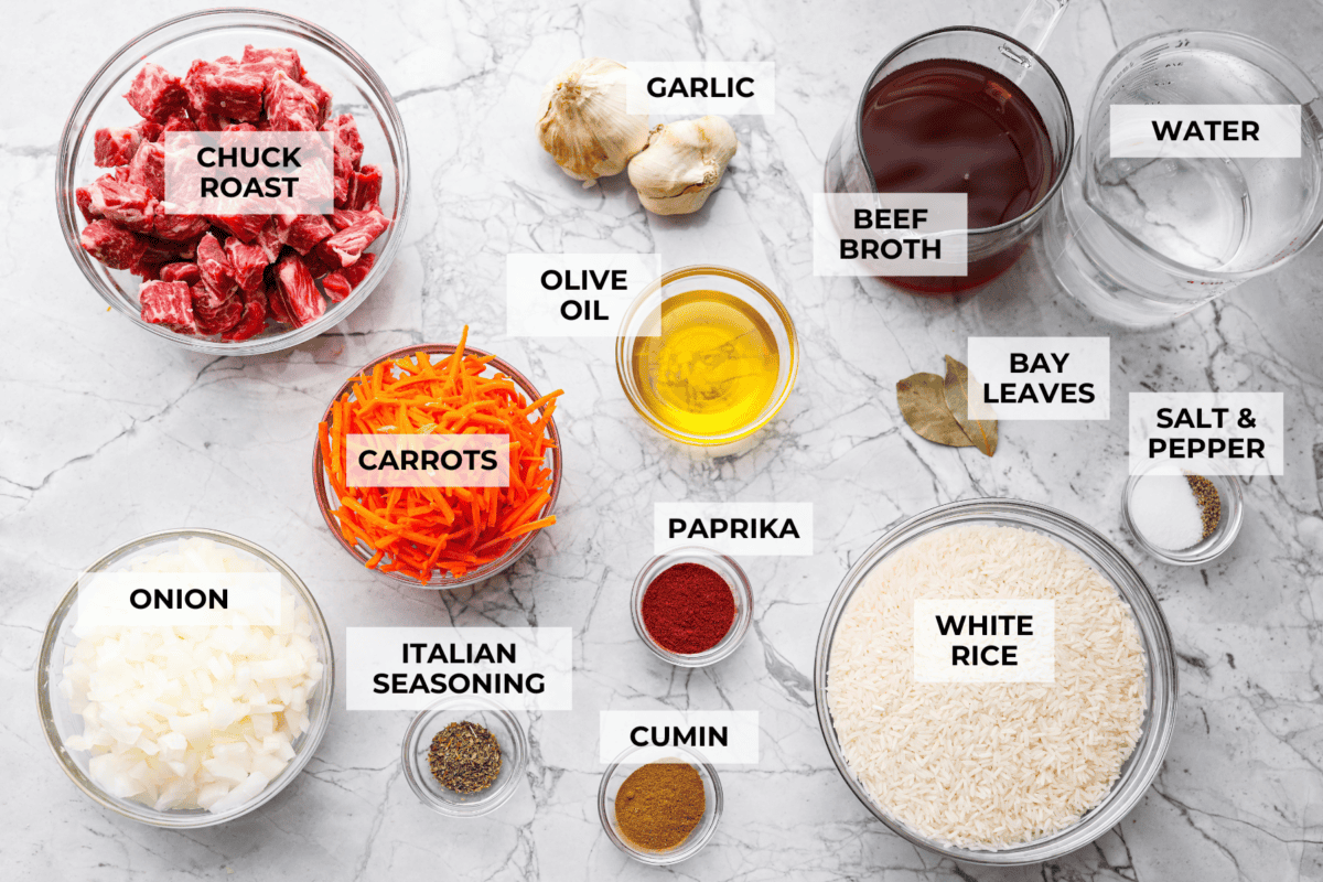 My one pot beef and rice has tender beef, fluffy rice, carrots, and warm spices all cooked in one pot. But one special ingredient is the secret to its incredible flavor. Keep reading to find out what it is! Overhead shot of labeled one pot beef and rice ingredients.