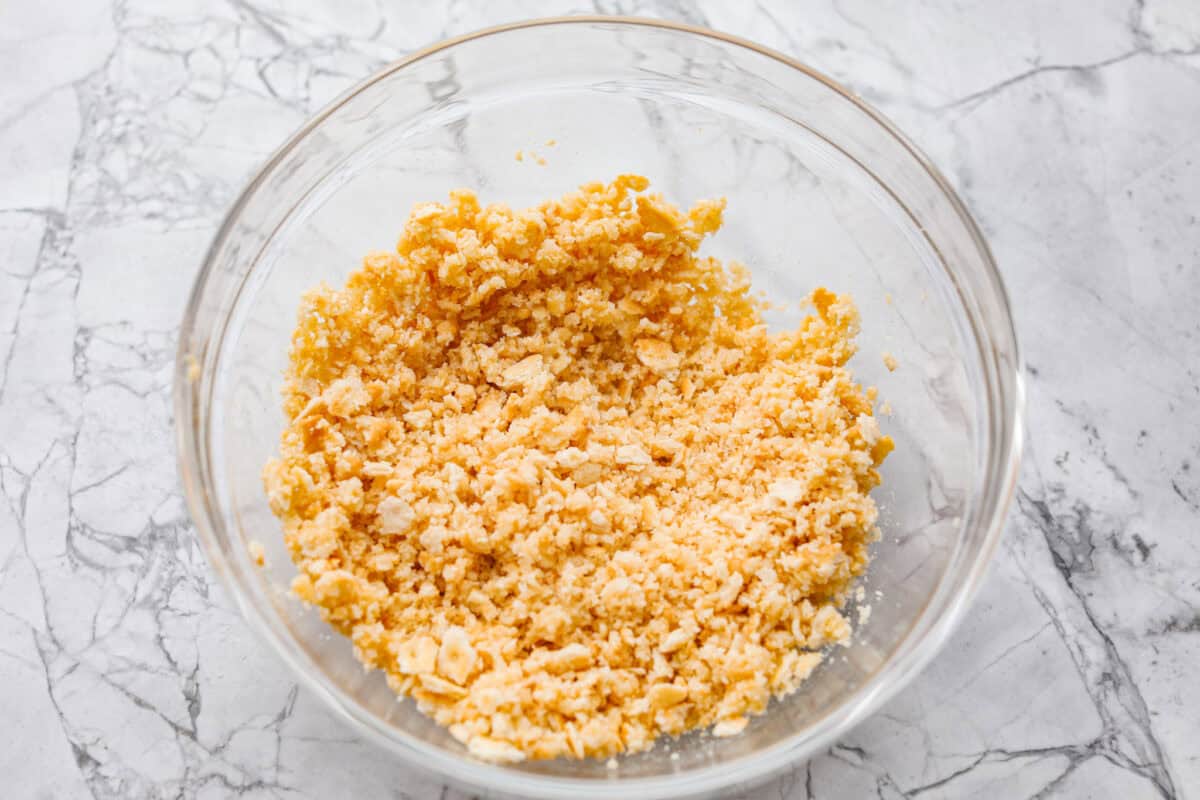Crushed Ritz crackers and butter mixed together in a bowl. 