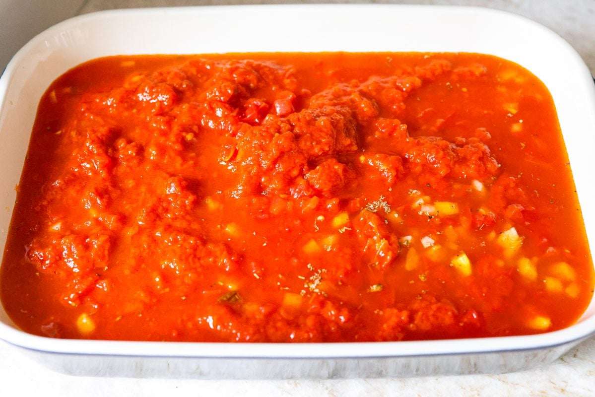 Marinara sauce, bell pepper, broth, onion and fresh basil added to the top of the dry noodles. 