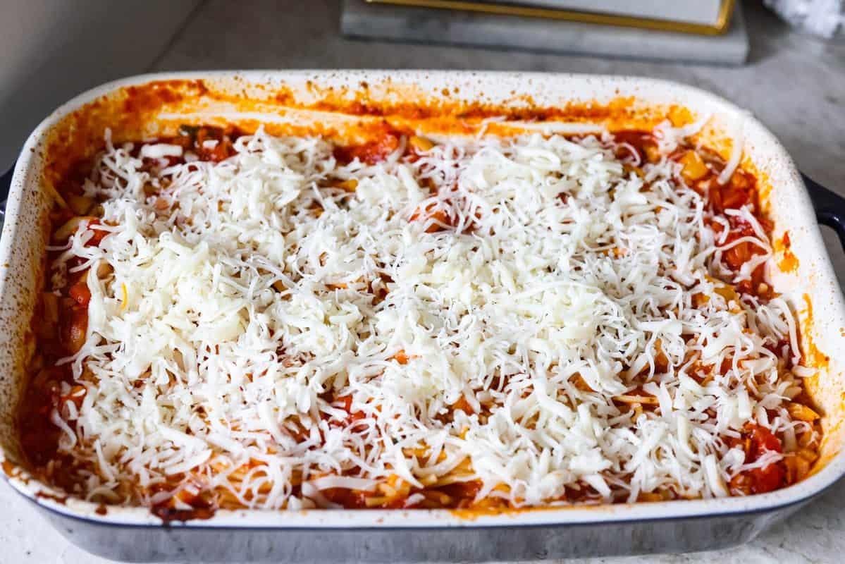 Cheese added to the top of the baked spaghetti. 