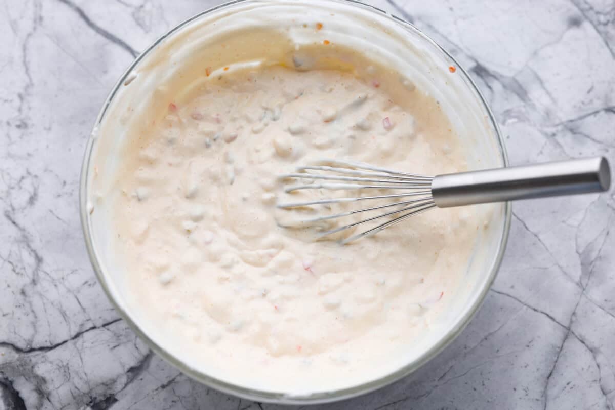 Say hello to Oklahoma dip, the viral party dip with serious dirty martini vibes! Creamy mayo, salty green olives, blue cheese, and buttermilk come together. This bold, briny dip that’s perfect for dunking, spreading, and scooping. Everything all whisked together.