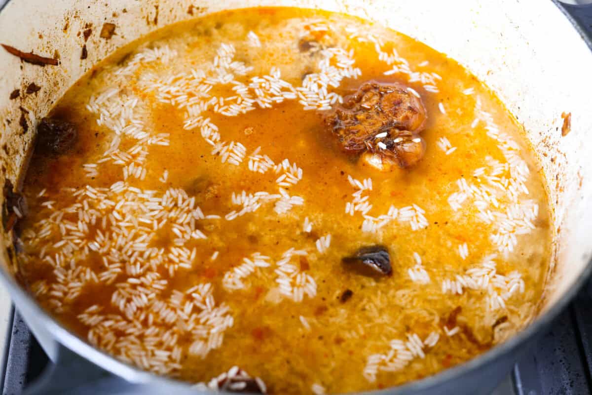 My one pot beef and rice has tender beef, fluffy rice, carrots, and warm spices all cooked in one pot. But one special ingredient is the secret to its incredible flavor. Keep reading to find out what it is! Rice and water added and ready to cook.