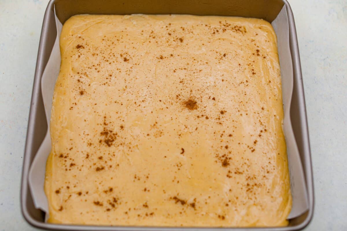 4-ingredient pumpkin fudge is the perfect treat when I want something sweet with a pumpkin-spice vibe. Four simple ingredients and a few minutes of prep make this creamy fall favorite. Fudge ingredients all combined and added to the baking dish.