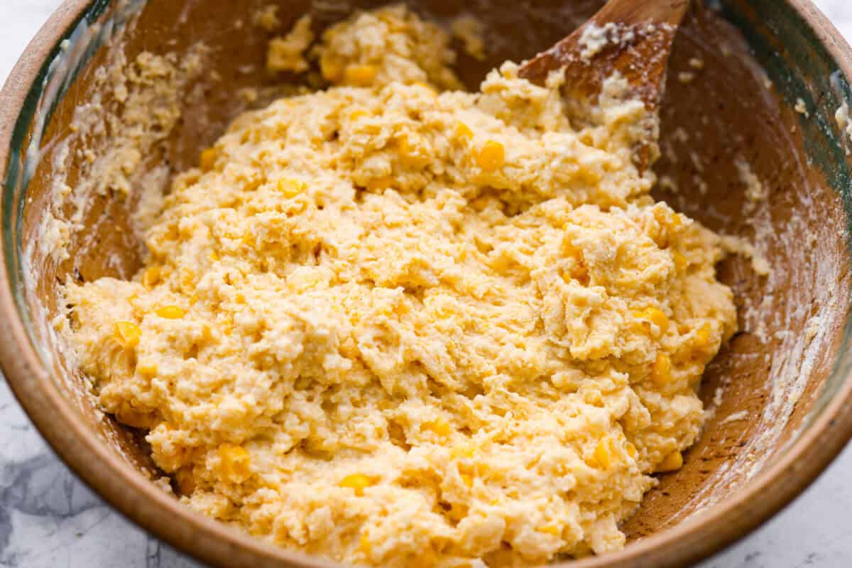 Butter swim cornbread bakes in a whole stick of butter, giving it crisp, golden edges and a soft, tender center. My secret ingredient is a can of creamed corn, which makes it extra moist and adds even more sweet corn flavor. Cornbread batter ready to go into the pan.