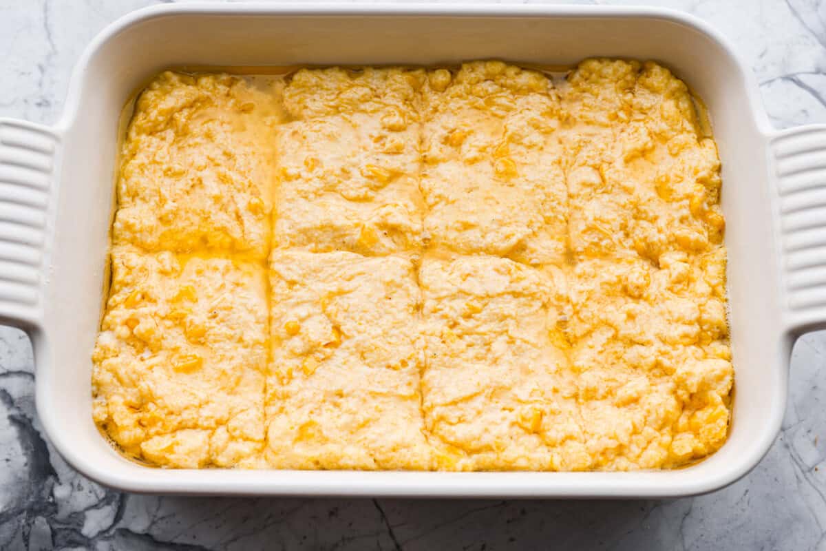 Butter swim cornbread bakes in a whole stick of butter, giving it crisp, golden edges and a soft, tender center. My secret ingredient is a can of creamed corn, which makes it extra moist and adds even more sweet corn flavor.
