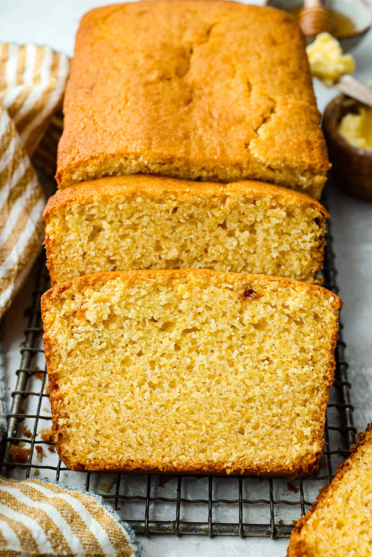 Cornbread loaf with a couple of slices cut out of it. 