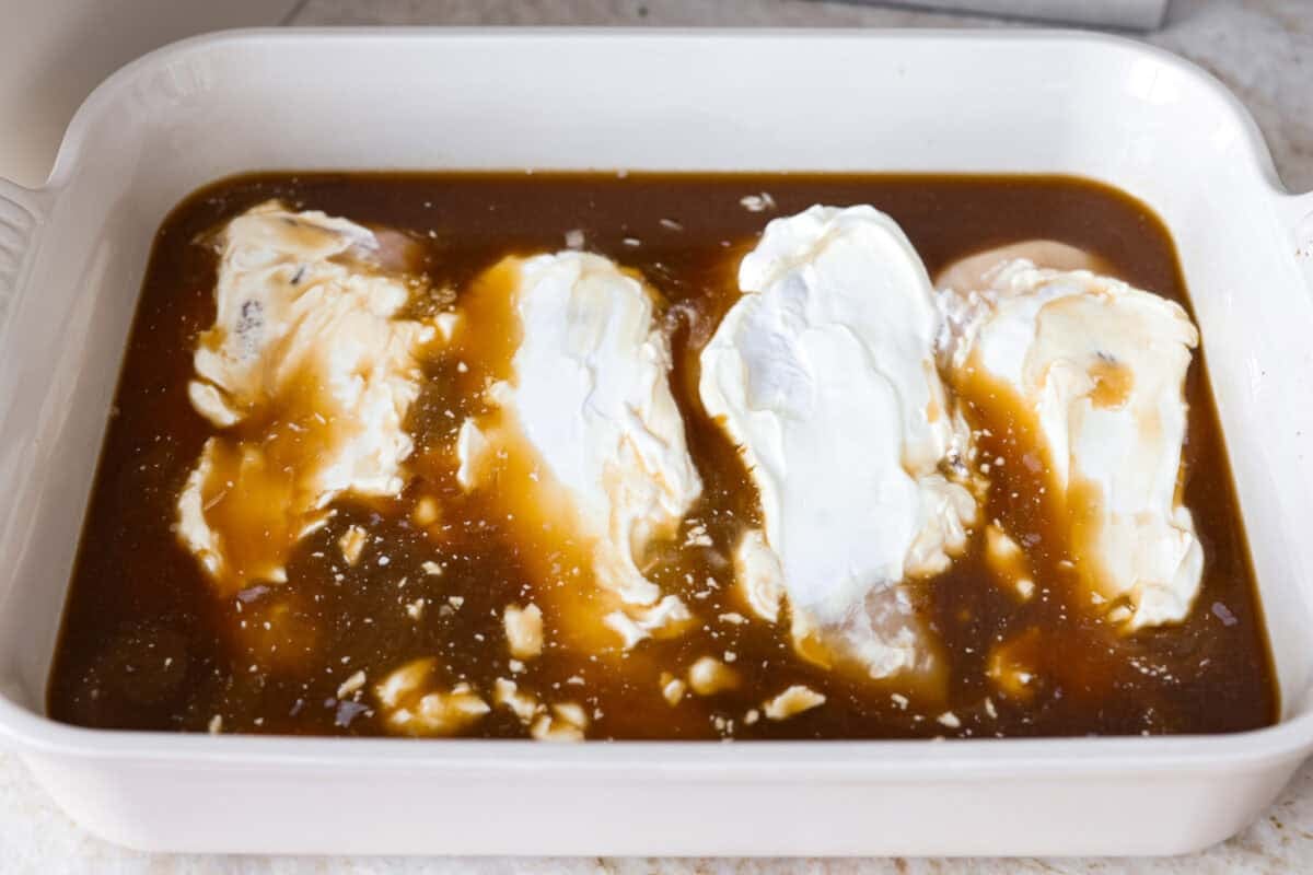 French onion chicken and rice casserole brings the rich, savory flavor of French onion soup to an easy, cheesy dinner. Tender chicken, fluffy rice, melty provolone, and crispy fried onions all come together in one pan with just 10 minutes of prep. Sour cream spread over the chicken breasts.