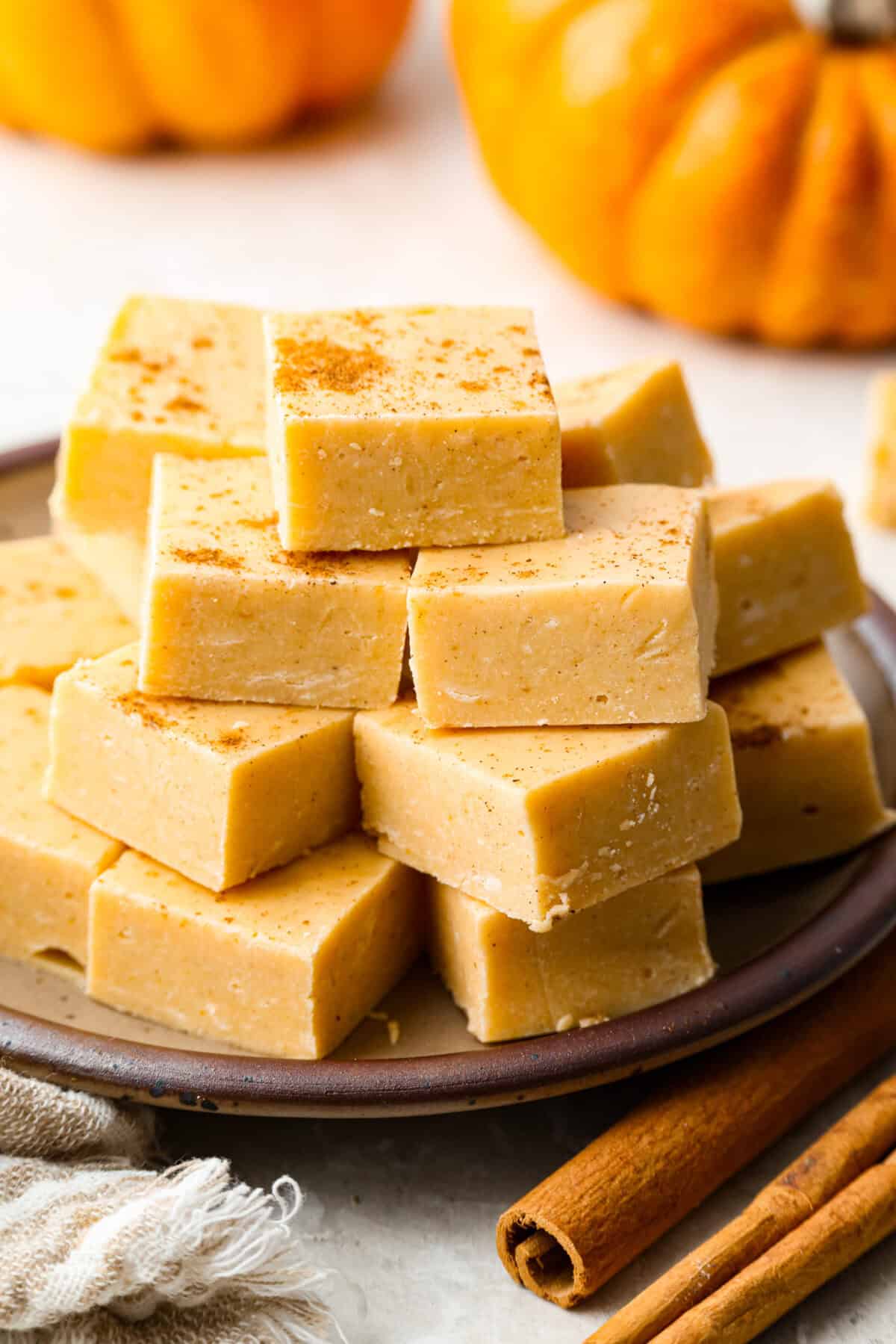 4-ingredient pumpkin fudge is the perfect treat when I want something sw4-ingredient pumpkin fudge is the perfect treat when I want something sweet with a pumpkin-spice vibe. Four simple ingredients and a few minutes of prep make this creamy fall favorite. Stack of 4 ingredient pumpkin fudge in front of some mini pumpkins.