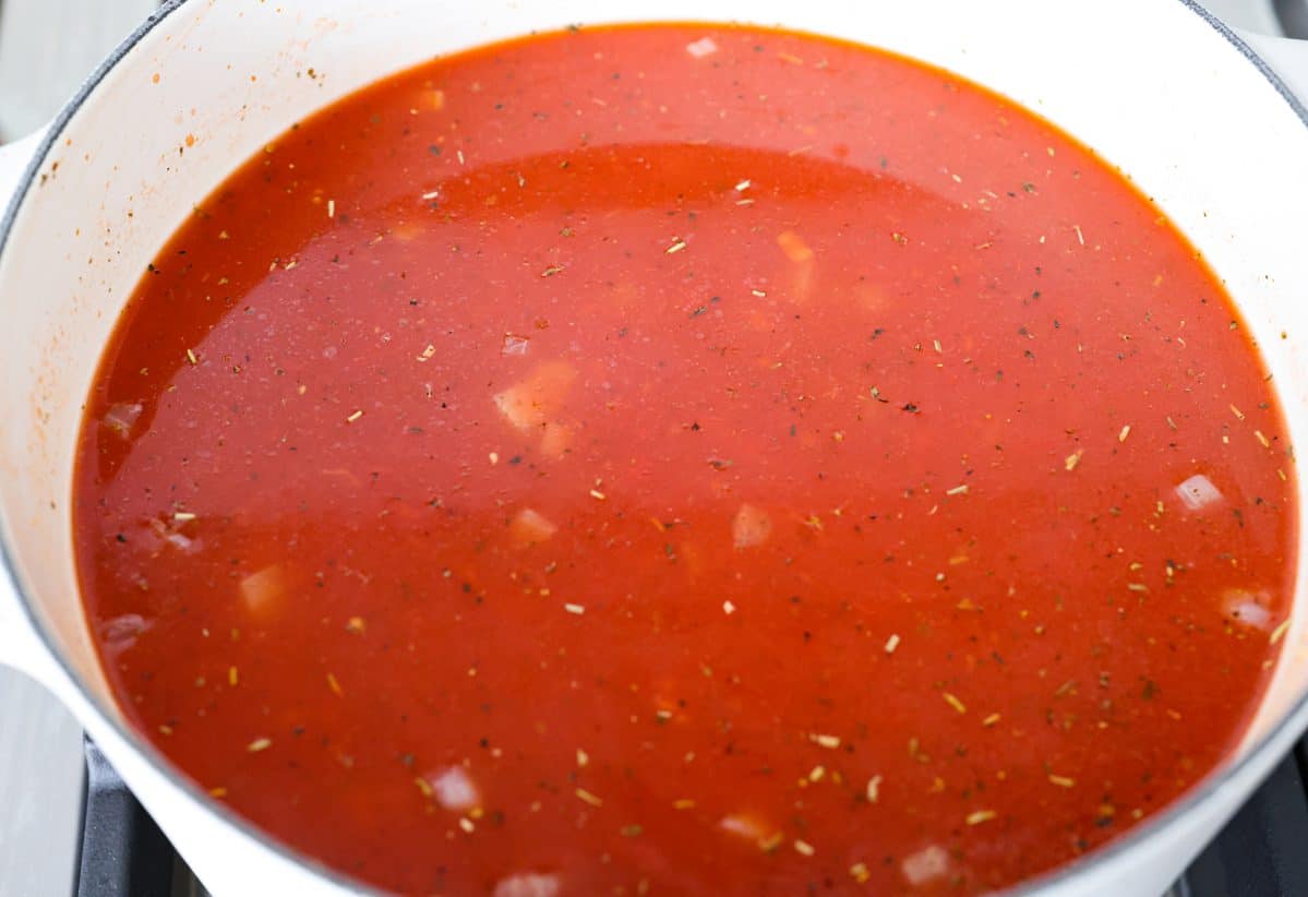 Craving chicken parm? Grab a spoon! This chicken parmesan soup is loaded with tender chicken, pasta, and a rich, creamy tomato broth. Finish with crispy, buttery breadcrumbs for a delicious twist on the Italian classic! Crushed tomatoes and tomatoes sauce added to the pot with the onion mixture.