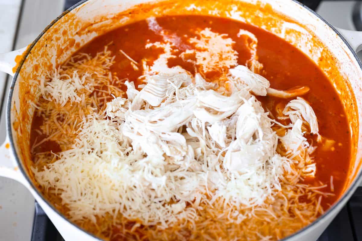 Craving chicken parm? Grab a spoon! This chicken parmesan soup is loaded with tender chicken, pasta, and a rich, creamy tomato broth. Finish with crispy, buttery breadcrumbs for a delicious twist on the Italian classic! Shredded chicken, heavy cream, and Parmesan cheese added to the pot.