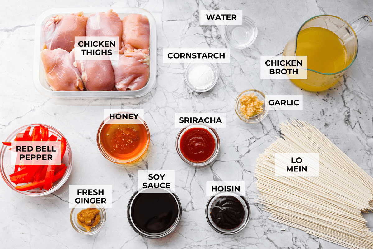 Overhead shot of labeled slow cooker honey garlic chicken noodles ingredients. 