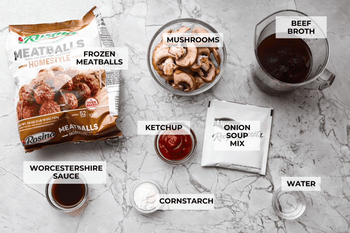 Slow cooker Salisbury steak meatballs are the ultimate comfort food! Tender meatballs and mushrooms simmer in a rich, savory gravy, and the best part? You only need 5 minutes of prep! Overhead shot of labeled salisbury steak meatballs ingredients.