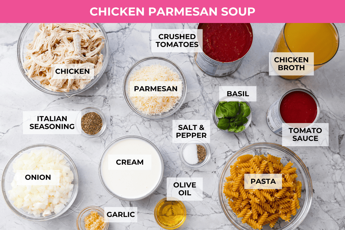 Craving chicken parm? Grab a spoon! This chicken parmesan soup is loaded with tender chicken, pasta, and a rich, creamy tomato broth. Finish with crispy, buttery breadcrumbs for a delicious twist on the Italian classic! Overhead shot of labeled chicken parmesan soup ingredients.