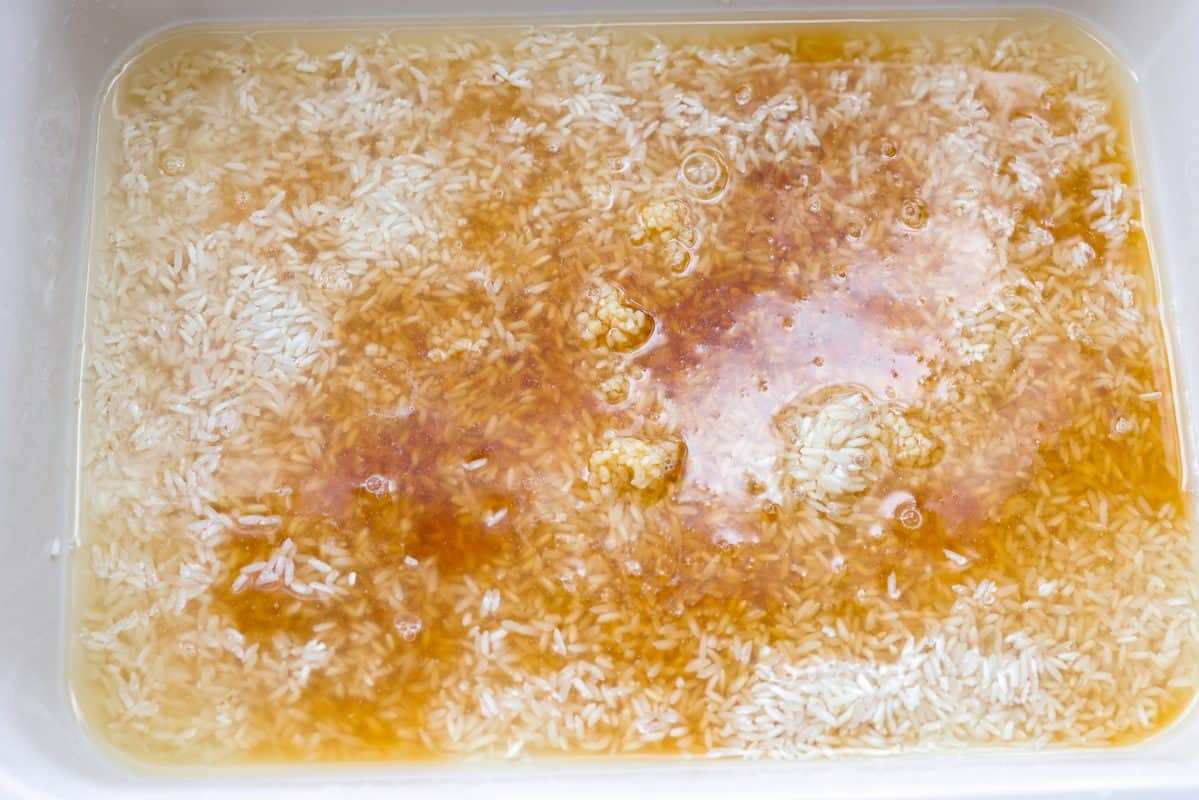 Rice, broth and other sauces added to the baking dish.