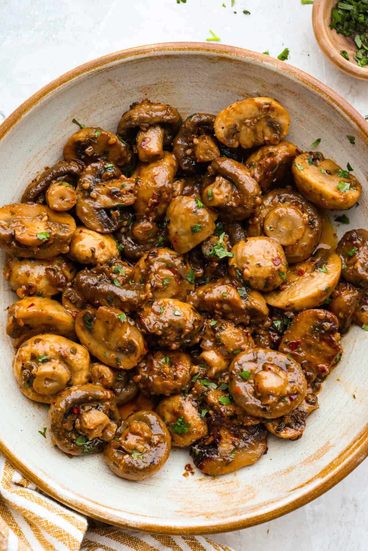 These Cowboy Mushrooms are so easy to make and packed with flavor! Tender, juicy mushrooms are coated in rich, garlicky cowboy butter. Just two ingredients and you've got a side dish that might steal the show! Bowl of cowboy mushrooms soaking in delicious seasoned butter.