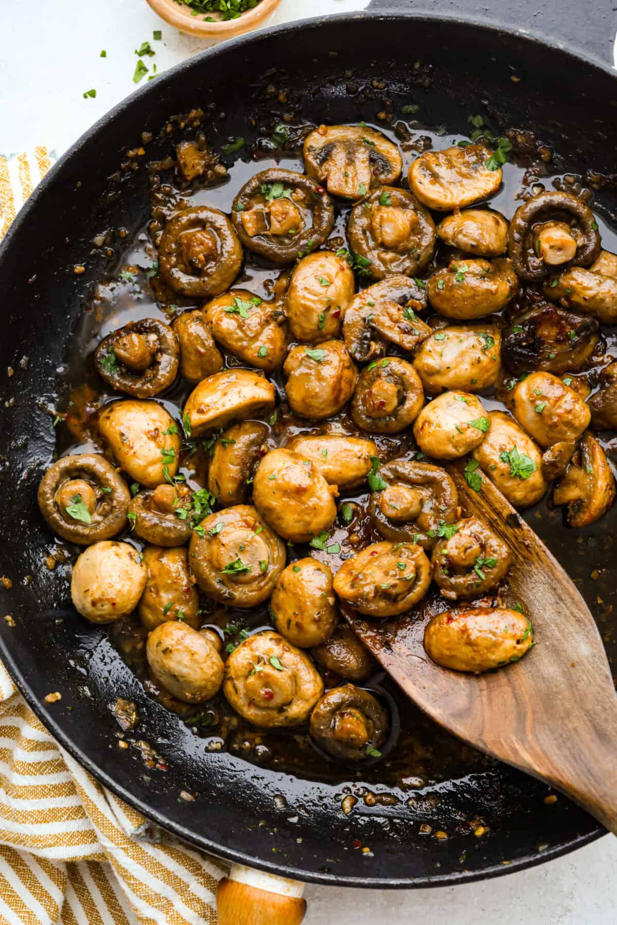 These Cowboy Mushrooms are so easy to make and packed with flavor! Tender, juicy mushrooms are coated in rich, garlicky cowboy butter. Just two ingredients and you've got a side dish that might steal the show! Skillet with tender cowboy mushrooms covered in butter, cooked and ready to devour.