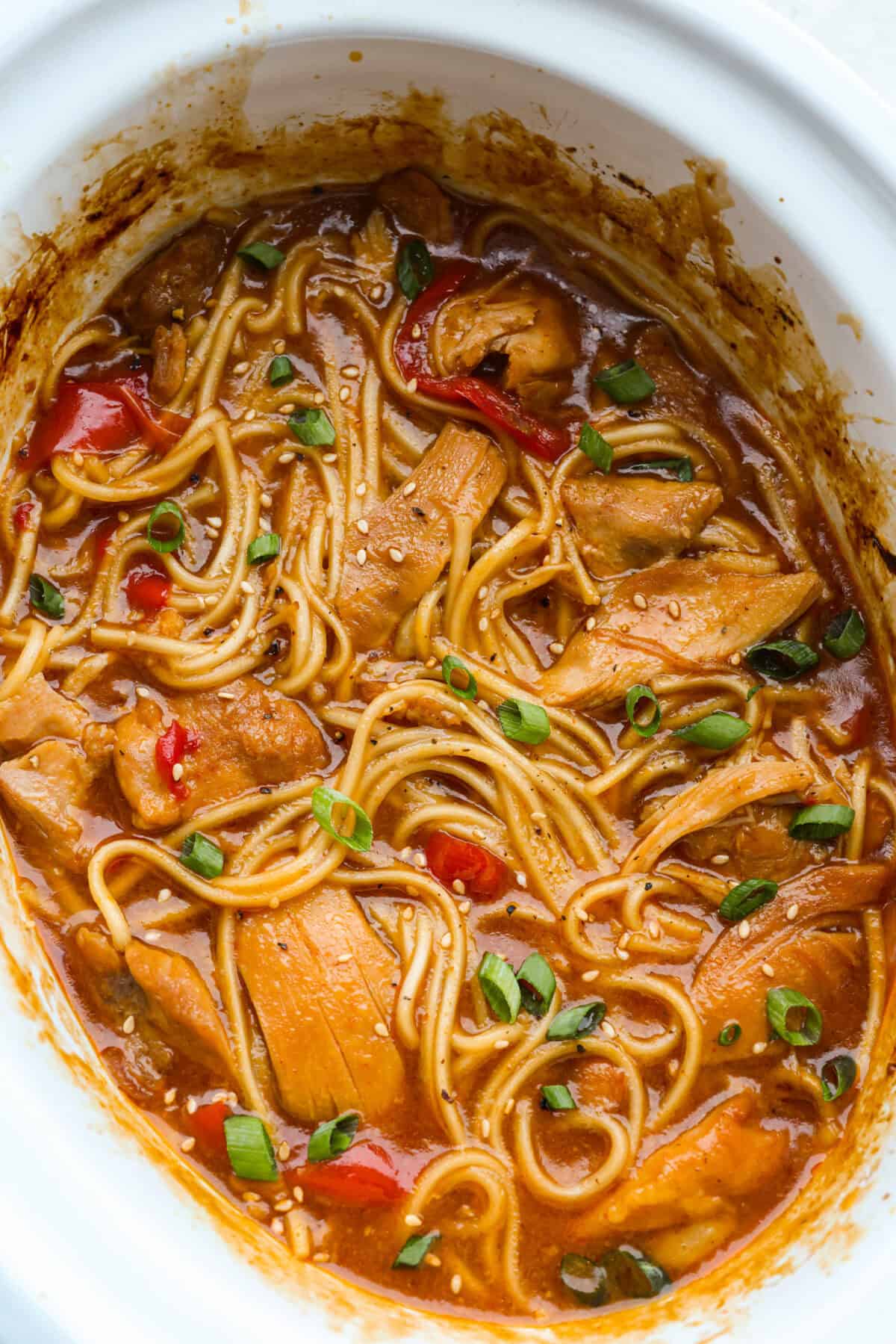 Top down shot of the cooked slow cooker honey garlic chicken noodles. 